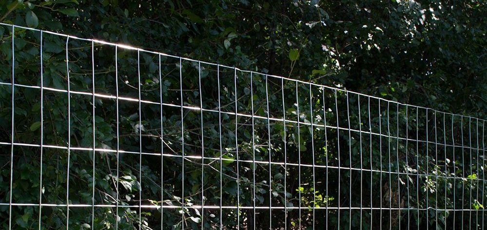 Welded wire mesh fencing in a green field